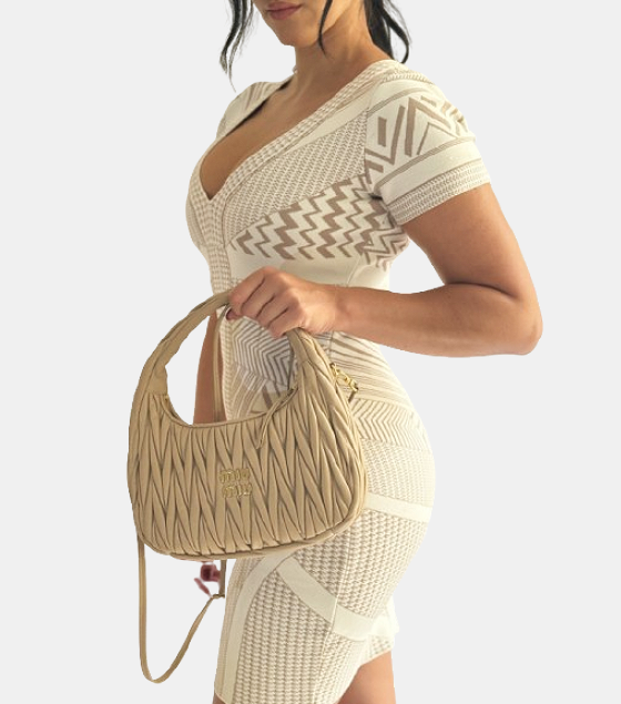 A light blue tory burch handbag is pictured.