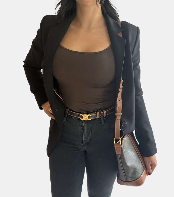 A pair of gold bracelets sitting on top of a velvet cushion